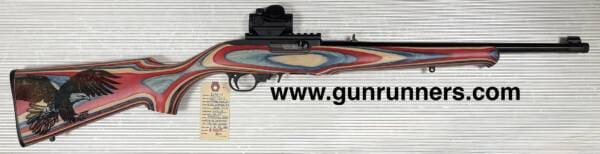 Sturm, Ruger, & Co. Inc., used, 10-22 Compact/Youth model, w/red, white, and blue laminated stock, with laser engraved American eagle on stock, suppressor ready 16.25” barrel, 1-10 round magazine, and a Bushnell red dot sight.