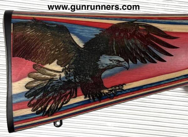 Sturm, Ruger, & Co. Inc., used, 10-22 Compact/Youth model, w/red, white, and blue laminated stock, with laser engraved American eagle on stock, suppressor ready 16.25” barrel, 1-10 round magazine, and a Bushnell red dot sight. - Image 2